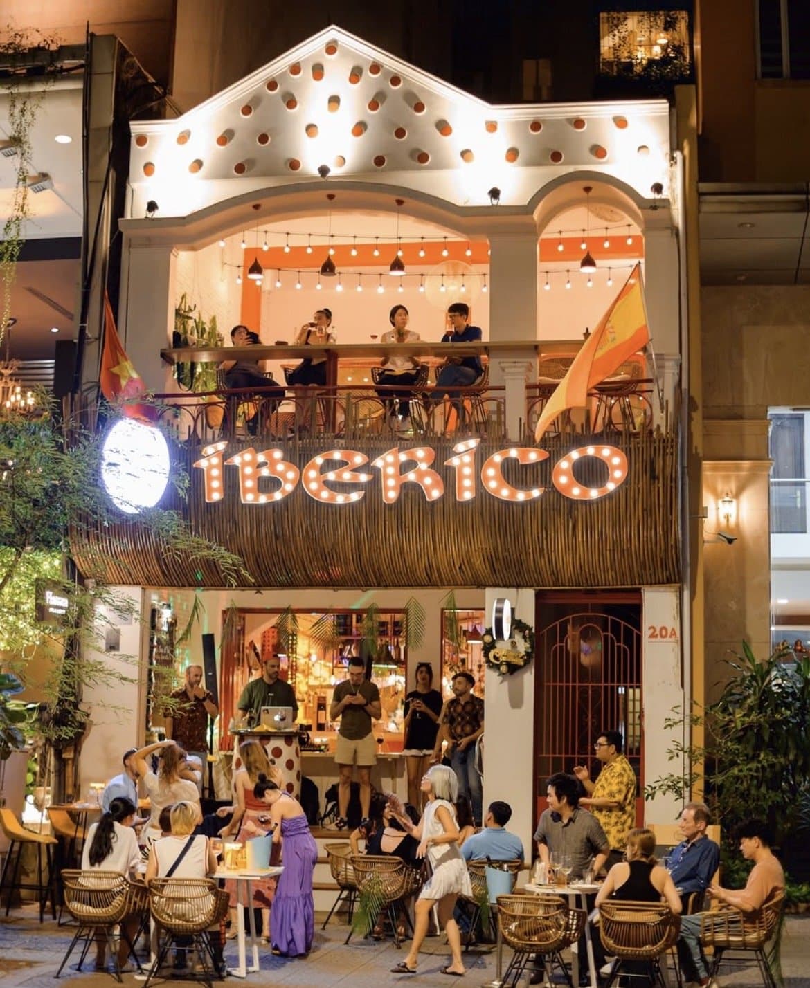 IBÉRICO Thị Sách glowing marquee sign and terrace at night