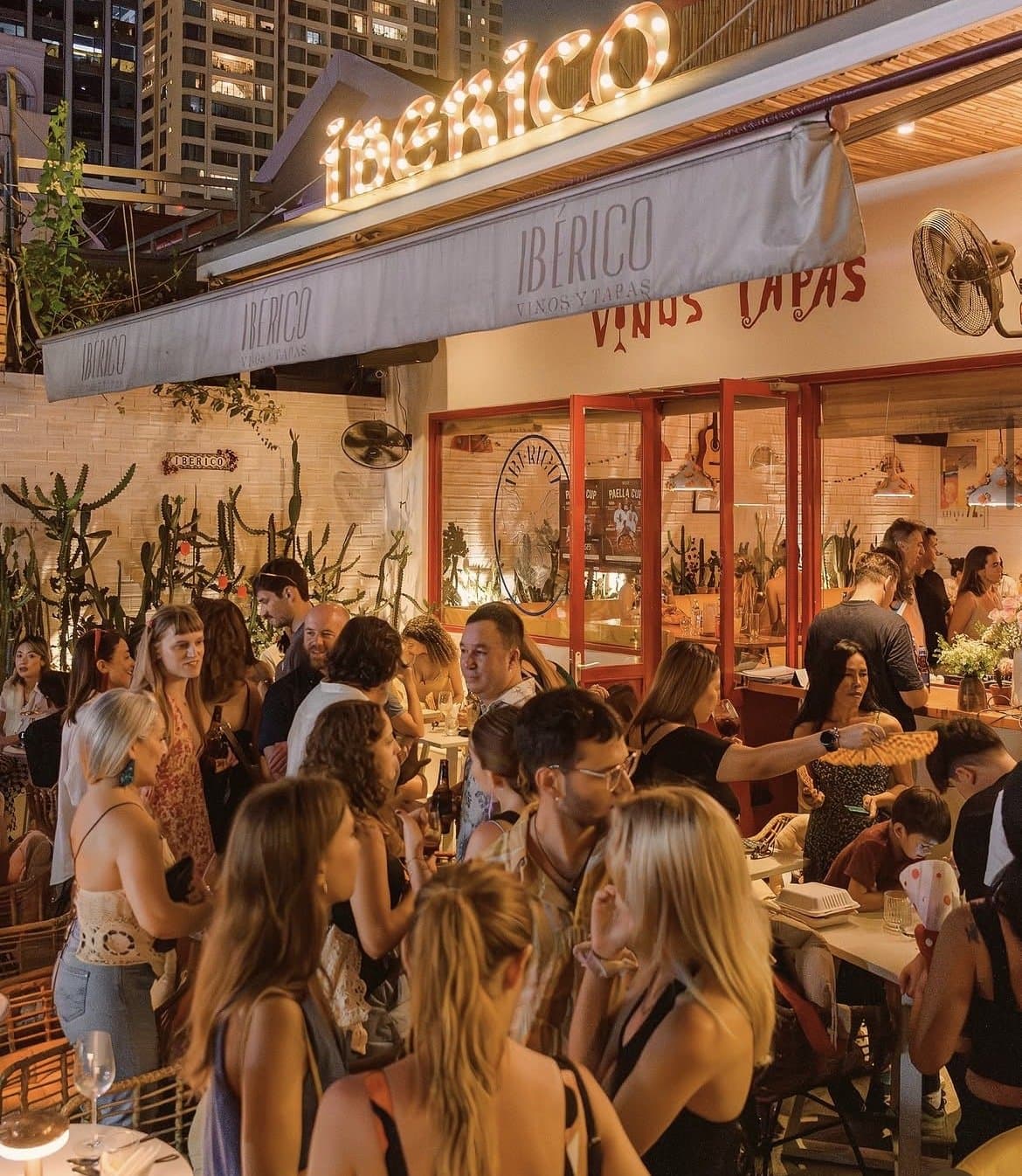 Guests toasting over tapas and wine at IBÉRICO